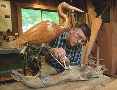 Bird carving studio, Rand Jack at work on one of his life size unpainted hardwood bird carvings